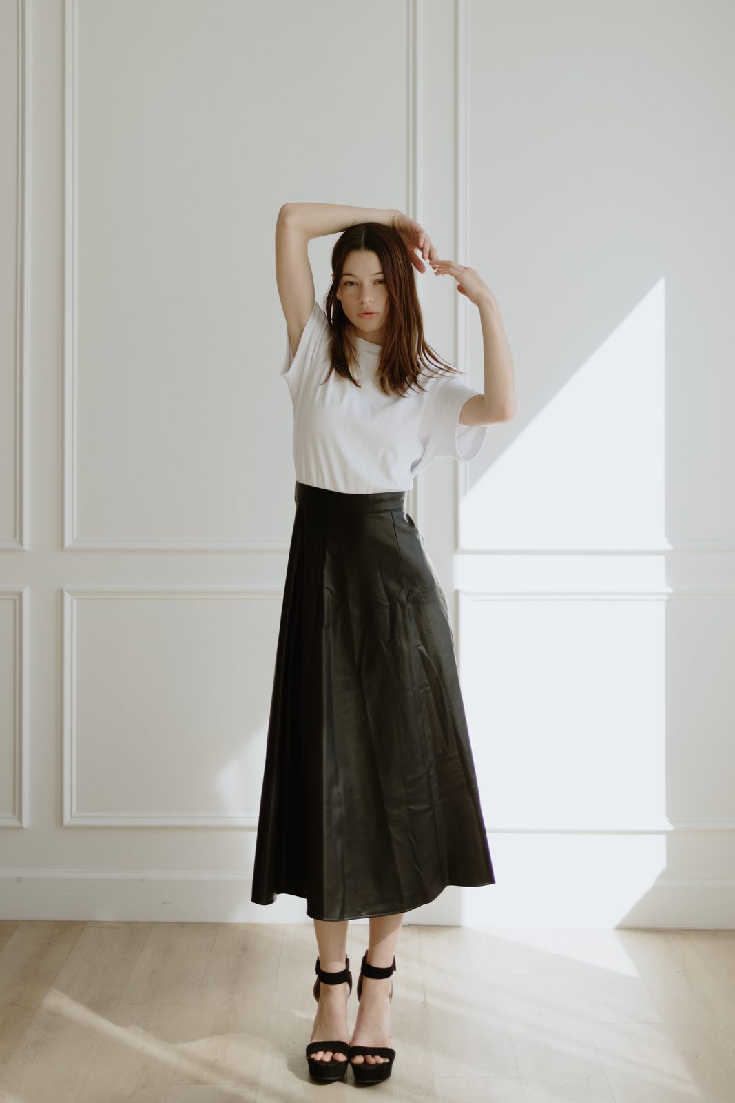 Editorial — leather skirt, arm raised
